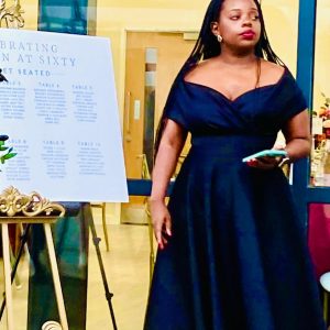 Lady in navy blue dress planning and coordinating a wedding