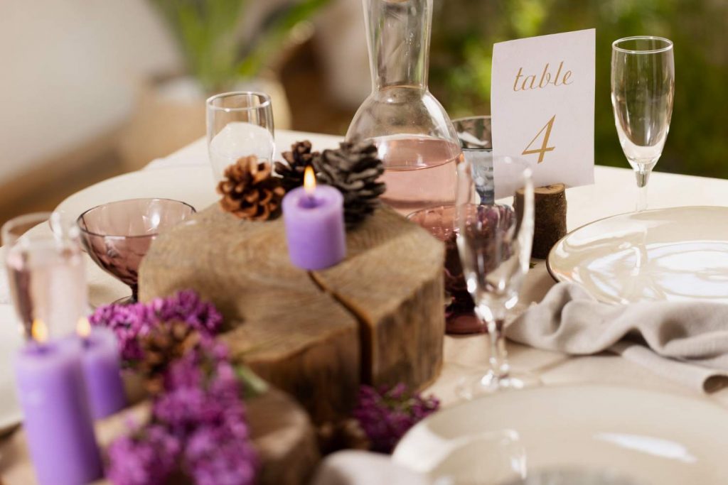 Wedding table with purple candles glasses